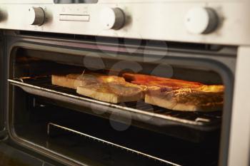 Cheese On Toast Being Grilled In Oven