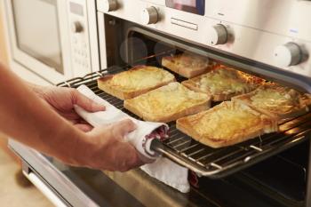 Cheese On Toast Being Grilled In Oven