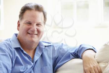 Portrait Of Overweight Man Sitting On Sofa