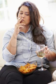Overweight Woman Eating Chips, Drinking Wine And Smoking
