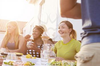 Group Of Young People Enjoying Outdoor Summer Meal