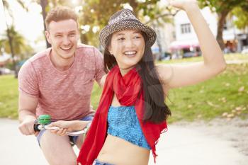 Young Couple Having Fun On Bicycle Ride