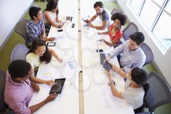 Overhead View Of Designers Meeting To Discuss New Ideas