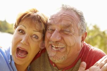 Head and Shoulders Portrait Of Senior Couple In Garden