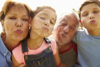 Portrait Of Grandparents And Grandchildren In Garden