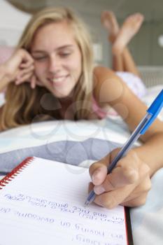 Teenage girl writing in diary