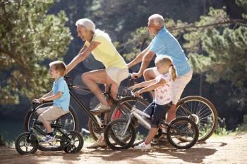 Senior couple with grandchildren on country bike ride