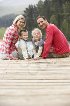 Family sitting on a jetty