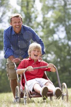 Father and son playing with go-kart