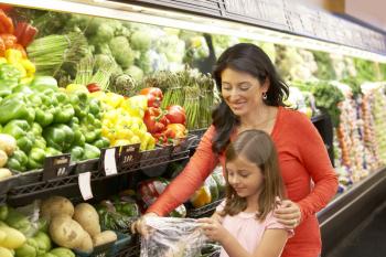 Mother and daughter shopping in supermarket