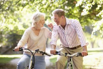 Senior couple cycling in park