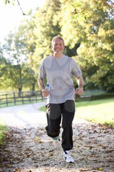 Senior man running in park