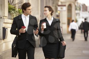 Businessman and businesswoman on their way to work