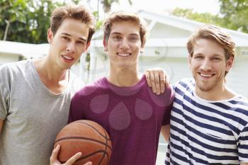 Portrait Of Young Men Playing Basketball Match