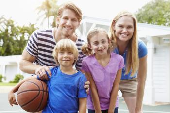 Portrait Of Family Playing Basketball Together