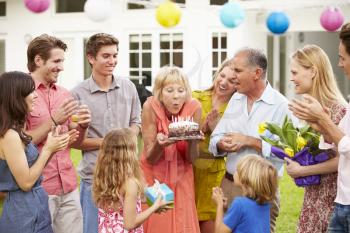 Multi Generation Family Celebrating Birthday In Garden