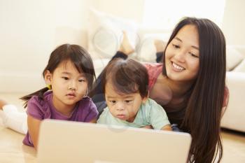 Mother And Children Using Laptop Together