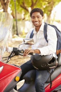 Young Man Riding Motor Scooter To Work