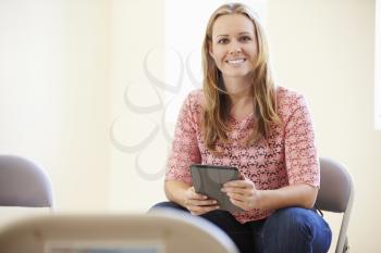 Businesswoman In Office Using Digital Tablet