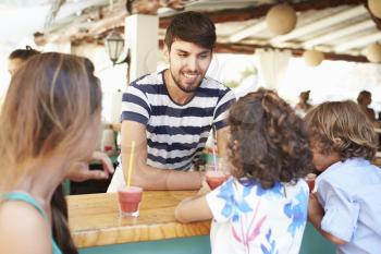 Man Making Children Fruit Smoothies In Restaurant