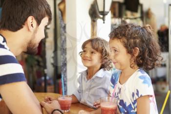 Children Drinking Fruit Smoothies In Restaurant