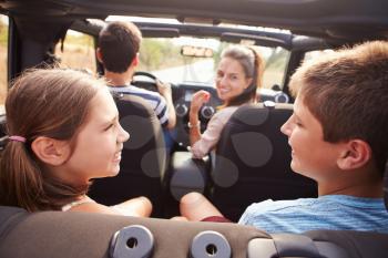 Parents Taking Children On Trip In Open Top Car