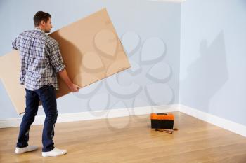 Man Preparing To Assemble Flat Pack Furniture