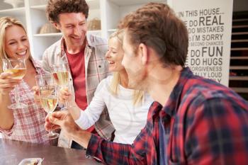 Four friends celebrating at home