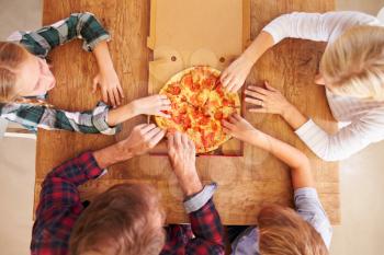 Family eating pizza together, overhead view