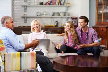 Parents With Adult Offspring Using Digital Devices At Home