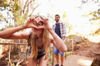 Woman On Walk With Man Making Heart Shape At Camera