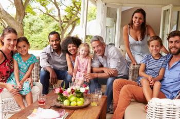 Family and friends posing for a picture in a conservatory