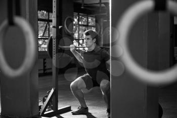 Black And White Shot Of Man Clean And Jerk Lifting Weights