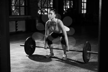 Black And White Shot Of Woman Preparing to Lift Weights