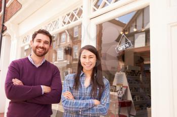 Couple standing in front of a shop window