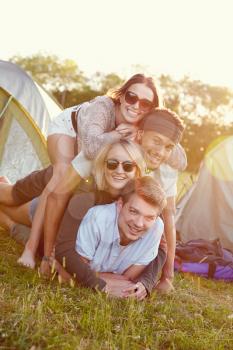 Group Of Friends Having Fun Outside Tents On Camping Holiday