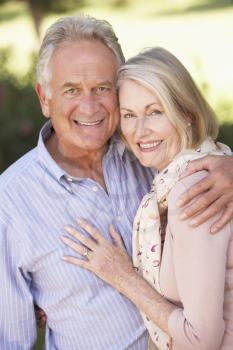 Portrait Of Romantic Senior Couple Relaxing In Countryside