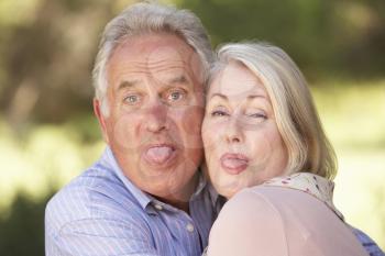 Portrait Of Senior Couple Pulling Faces Outside
