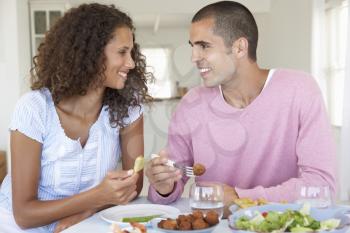 Young Couple Enjoying Meal At Home