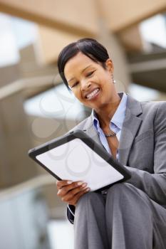 Businesswoman using tablet outdoors