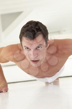 Young Bare Chested Man Exercising At Home