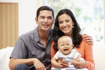 Hispanic couple at home with baby