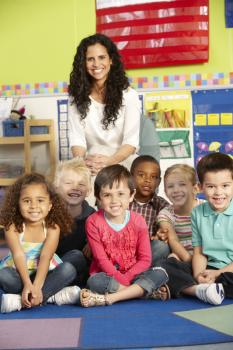 Group Of Elementary Age Schoolchildren In Class With Teacher