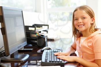 Young girl using computer at home