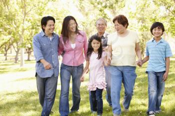 Multi-generation Asian family walking in park