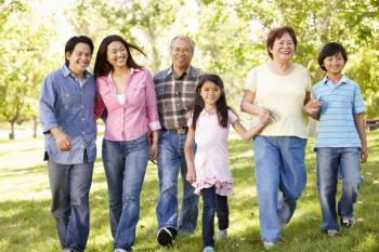 Multi-generation Asian family walking in park