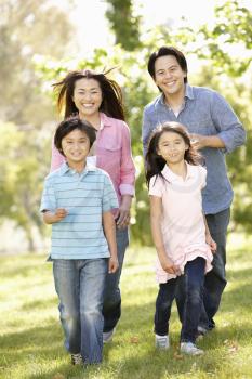 Asian family running in park