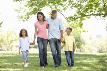 Young African American Family Enjoying Walk In Park