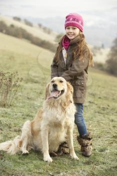Girl on country walk with dog in winter