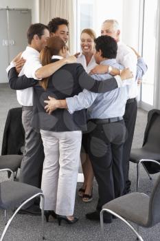Group Of Businesspeople Bonding In Circle At Company Seminar